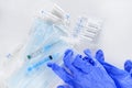 Blue masks, medicines, ampoules, medical gloves, syringes on a white background