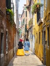 Masks walking in a Venetian alley