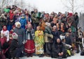 Maslenitsa. Croud of people wearing traditional Russian closes geatherred on a snowy hill to be photographed