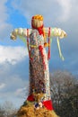 Maslenitsa doll. Blue sky with clouds background.