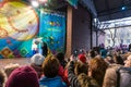 Maslenitsa (pancake week). People looking at the trainer with the bear wich performs on stage.