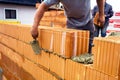 Mason with brick on construction site Royalty Free Stock Photo