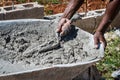 Mason/bricklayer/construction worker scooping wet cement from wheel barrow Royalty Free Stock Photo