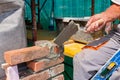 Worker is building wall of brick of building under construction Royalty Free Stock Photo
