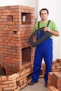 Mason building a traditional stove from bricks Royalty Free Stock Photo