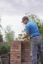 Mason building wall with bricks Royalty Free Stock Photo