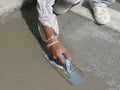 Mason hand finishes a newly poured concrete floor