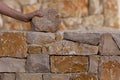 Mason hands working on masonry stone wall Royalty Free Stock Photo