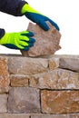 Mason hands working on masonry stone wall Royalty Free Stock Photo