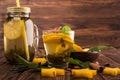 A mason jar of chinese tea on a wooden background. A cup of sweet green tea. Lemon tea with exotic spices. Copy space.