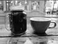 Mason Jar Coffee Mug and Classic Ceramic Coffee Cup on a Window Counter