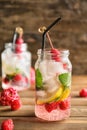 Mason jar of fresh raspberry lemonade on wooden table Royalty Free Stock Photo