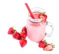 A mason jar full of organic shake. A bubbled pink milkshake on a white background. A sweet smoothie and raw strawberries. Royalty Free Stock Photo