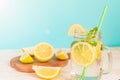 Mason jar glass of homemade lemonade with lemons, mint and green paper straw on wooden rustic background. Summer refreshing Royalty Free Stock Photo