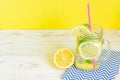 Mason jar glass of homemade lemonade with lemons, mint and red paper straw on wooden rustic background. Summer refreshing beverage Royalty Free Stock Photo