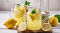 Mason jar glasses of homemade refreshing lemonade with slices of organic ripe lemon, whole and halves, squeezer on a rustic white Royalty Free Stock Photo
