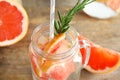 Mason jar of infused water with grapefruit slices on table