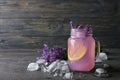 Mason jar with lavender lemonade and ice cubes on grey table Royalty Free Stock Photo