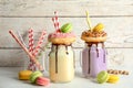 Mason jars with delicious milk shakes and macaroons