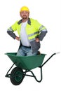 Mason kneeling in wheelbarrow Royalty Free Stock Photo