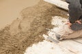 Mason leveling the cement screed Royalty Free Stock Photo