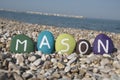 Mason, male name on colourful stones on pebbles