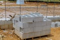 A mason man is laying the mounting a wall of aerated concrete blocks