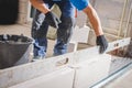 Mason plastering the concrete to build wall, Construction under building with mason plastering concrete to brick wall Royalty Free Stock Photo