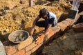 Mason Spreading Cement While Building Brick Foundation Royalty Free Stock Photo