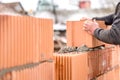 Mason worker bricklayer installing brick walls