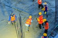 Mason worker leveling concrete with trowels, mason hands spreading poured concrete. Concreting workers are leveling poured liquid