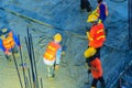 Mason worker leveling concrete with trowels, mason hands spreading poured concrete. Concreting workers are leveling poured liquid