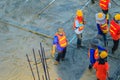 Mason worker leveling concrete with trowels, mason hands spreading poured concrete. Concreting workers are leveling poured liquid