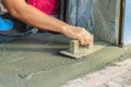Mason worker use trowel to smooth or leveling liquid concrete of Royalty Free Stock Photo