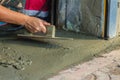 Mason worker use trowel to smooth or leveling liquid concrete of Royalty Free Stock Photo