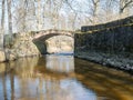 The Masonry bridge over the river of Kuja, a sunny day in early spring with clear blue skies, the banks of a small river Royalty Free Stock Photo