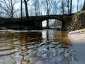 The Masonry bridge bridge over the river of Cuja, a sunny day in early spring with clear blue skies, the banks of a small river Royalty Free Stock Photo