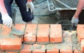 Masonry house wall construction.Bricklayers hands bricklaying house wall