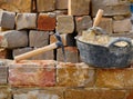 Masonry stone wall construction with tools Royalty Free Stock Photo