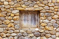 Masonry stone wall with grunge wood window Royalty Free Stock Photo