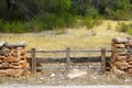 Masonry stone wall wooden fence pine forest Royalty Free Stock Photo