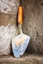 Masonry trowel on a concrete wall