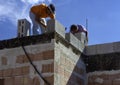 Masonry worker make concrete wall by cement block