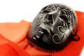 Masquerade black mask and a red scarf Royalty Free Stock Photo