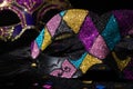 Masquerade mask with glitters and confetties on black background