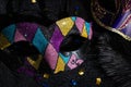 Masquerade mask with glitters and confetties on black background