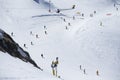 Mass descent of mountain skiers from a wide hillside