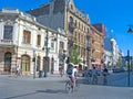 Mass tourism bike along city. Tourists ride around the city on bicycles rented