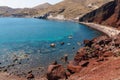 Mass Tourists enjoying summer holidays in popular red beach in Santorini, Greece