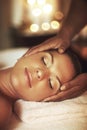 Massage aids relaxation. Closeup shot of a young woman enjoying a head massage at the spa. Royalty Free Stock Photo